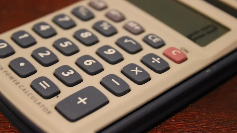 Close-up photograph of a calculator on a wooden desk