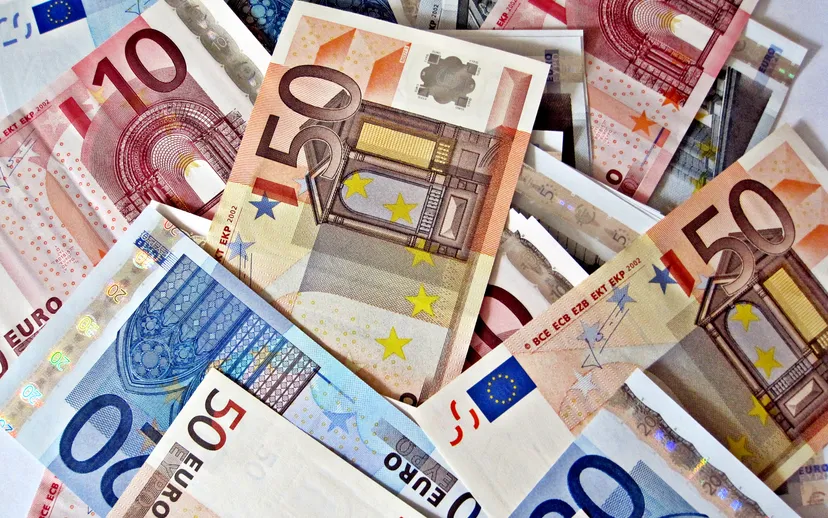 A scattered pile of euro banknotes in several denominations.
