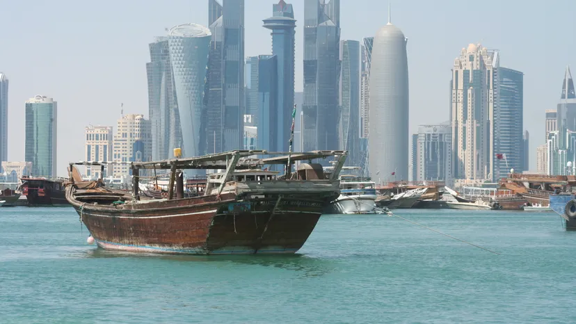 A traditional dhow in front of the West Bay towers in Doha