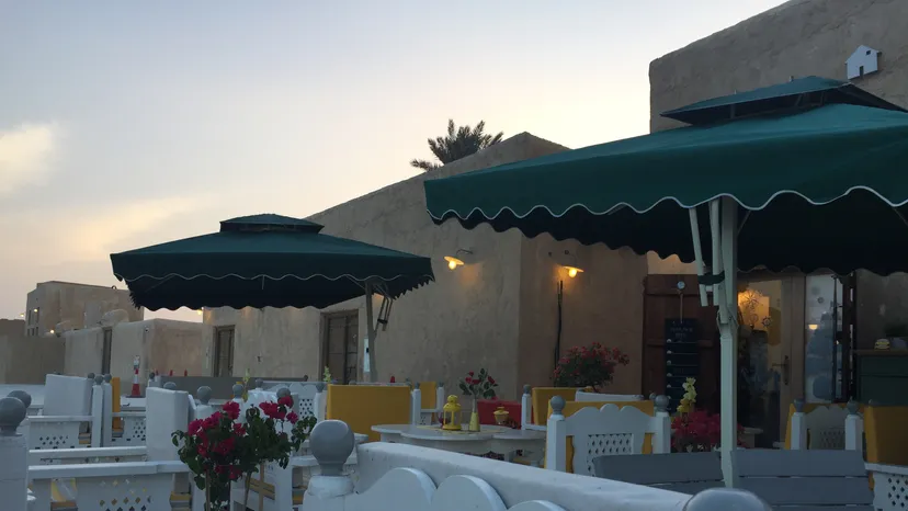 A small coffee shop with outdoor tables in the souq at Al Wakra
