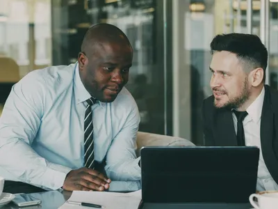 An adviser and a client discussing documents at a table